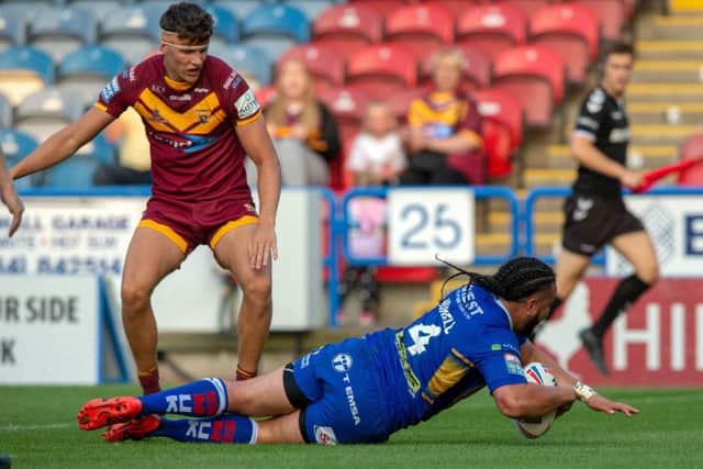 Konrad Hurrell dives in for his first and Rhinos' third try against Huddersfield Giants. PIC: Bruce Rollinson/JPIMedia