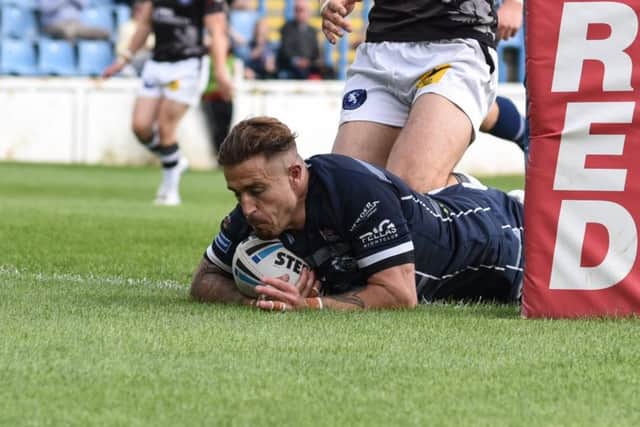 Cameron King touches the ball down for a try for Featherstone Rovers against Swinton Lions. Picture: Dec Hayes