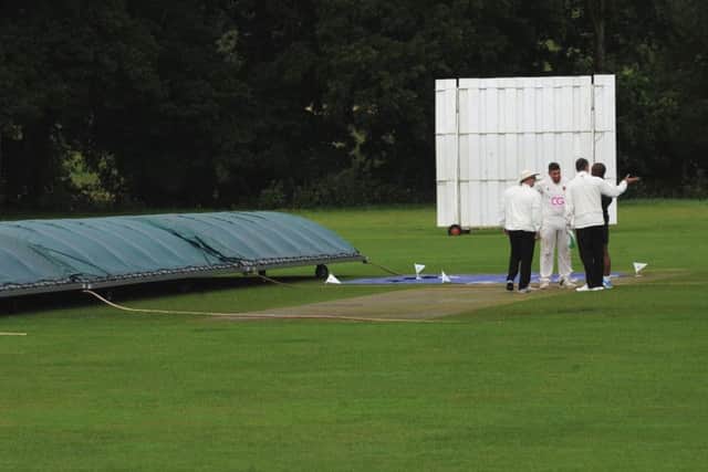 Umpires and captains discuss the pitch before calling off the game between Division 3 rivals Bardsey and Hall Park. PIC: Steve Riding