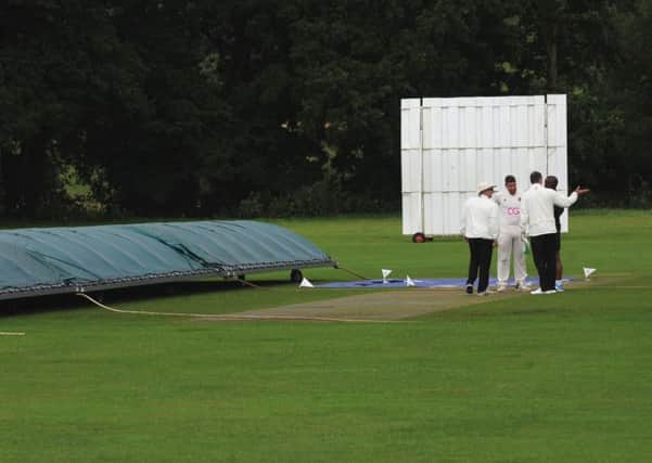 Umpires and captains discuss the pitch before calling off the game between Division 3 rivals Bardsey and Hall Park. PIC: Steve Riding