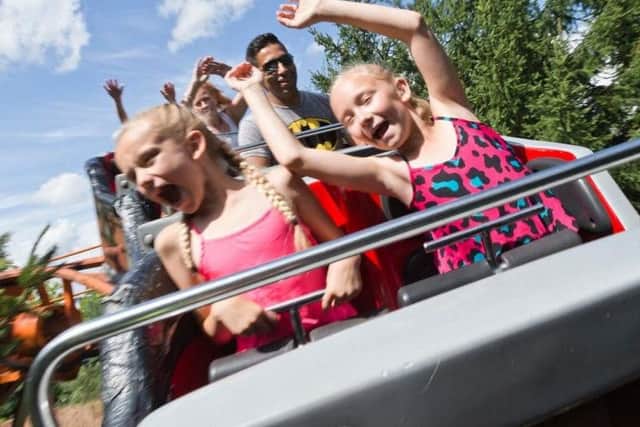 Enjoying a roller coaster.
