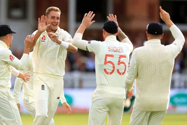 Englands Stuart Broad and team-mates celebrate taking the wicket of Australias David Warner at the end of day two of the Ashes Test match at Lords.