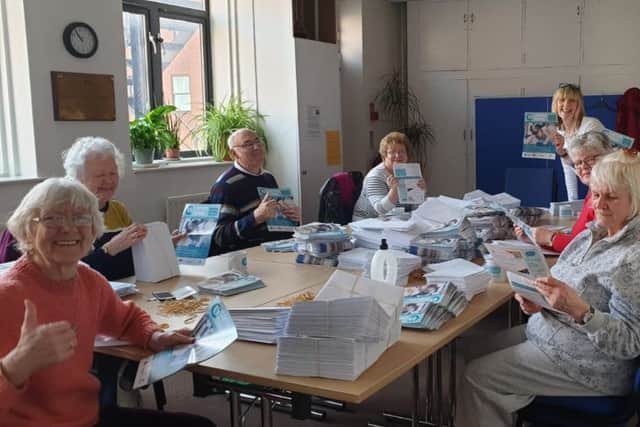 A group of volunteers get ready to mail out the Carers Leeds newsletter.