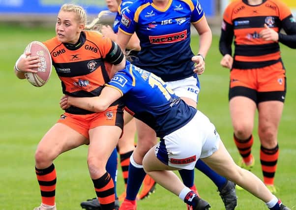 Castleford's Sinead Peach is tackled by Leeds Rhinos' Shannon Lacey and Sophie Nuttall.