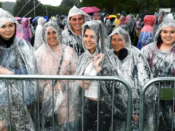 Fans in their ponchos queue to get into Ed Sheeran's gig at Roundhay Park.