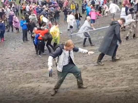 Concert goers struggle in the mud at Roundhay Park ahead of Ed Sheeran coming on stage on Friday evening. Picture: Stewart Clifton