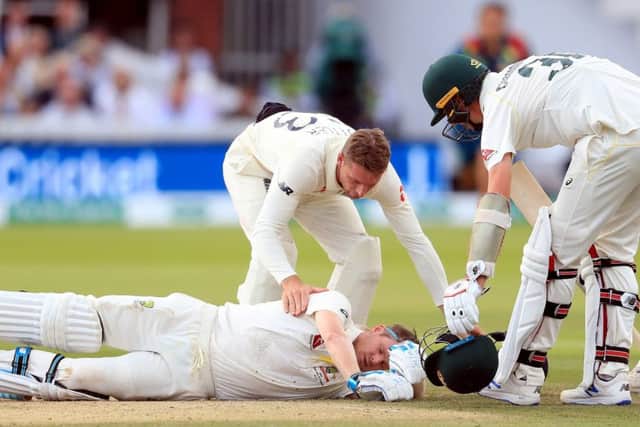 Australia's Steve Smith ends up on the floor after being hit by the ball.