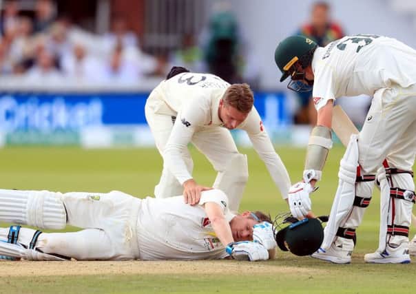 Australia's Steve Smith ends up on the floor after being hit by the ball.