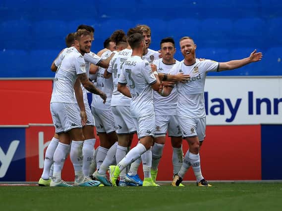 Leeds United players celebrate goal at Wigan Athletic