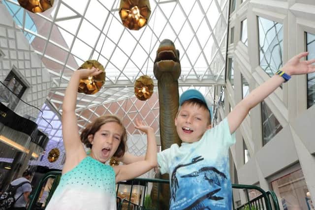 Liv Poucher and Joe Bartholomew roar with the dino at Victoria Leeds.