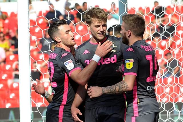 Patrick Bamford is congratulated after scoring Leeds United's third goal.