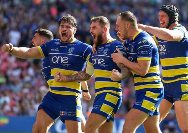 Warrington's Daryl Clark, centre, celebrates his match-winning try in the Challenge Cup final.