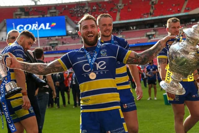Warrington's Daryl Clark celebrates with the Lance Todd trophy and the Challenge Cup.