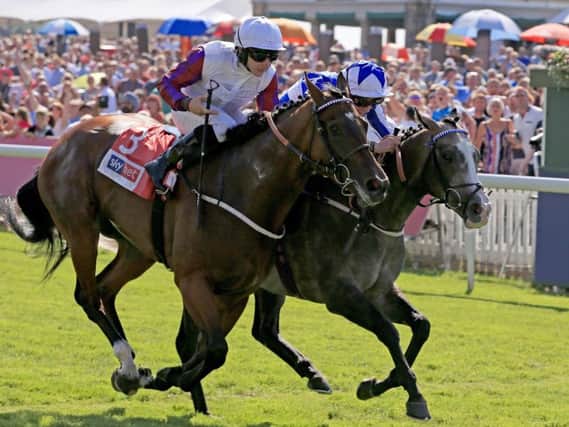 Shine So Bright (Right) ridden by Silvestre De Souza wins the Sky Bet City of York Stakes ahead of Laurens ridden by P J McDonald during Sky Bet Ebor Day of the Yorkshire Ebor Festival at York Racecourse. Pic: PA