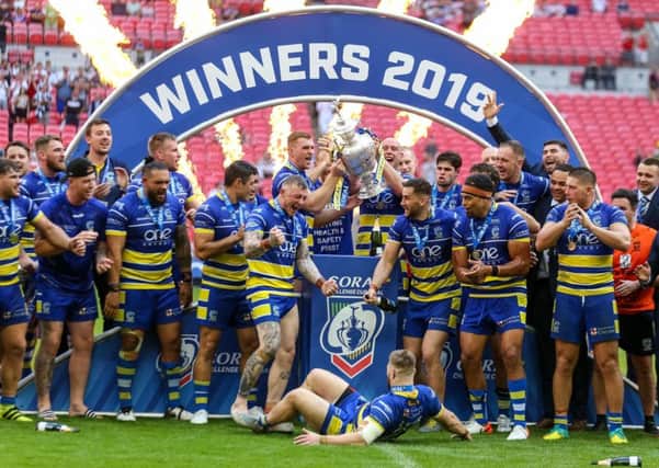 Warrington players celebrate their Challenge Cup final victory over St Helens.