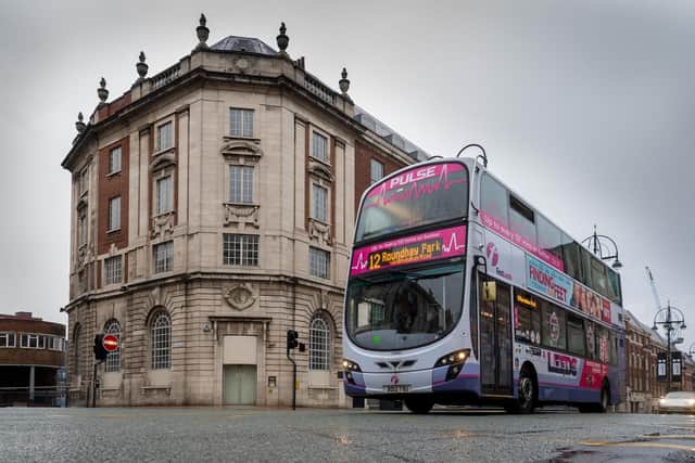 A bus makes its way through the city centre.