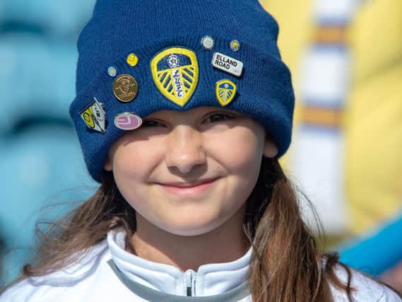 This young fan proudly shows off her Leeds badges.