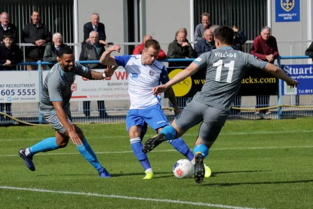 Lee Shaw fires a shot at the Curzon Ashton goal.