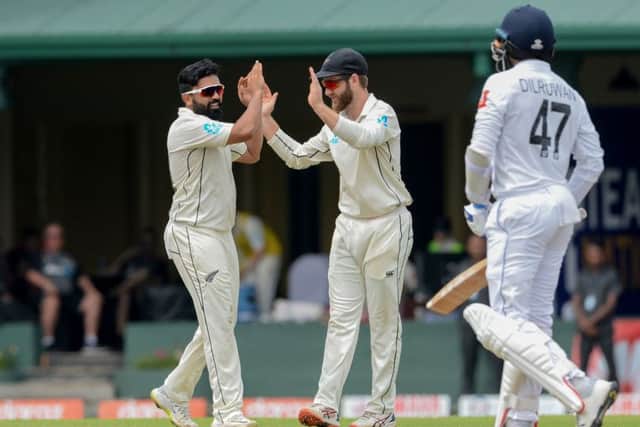 New Zealand's Ajaz Patel, left, is congratulated by captain Kane Williamson after dismissing Sri Lanka's Dilruwan Perera during last month's Test match in Colombo. Picture: LAKRUWAN WANNIARACHCHI/AFP/Getty Images)