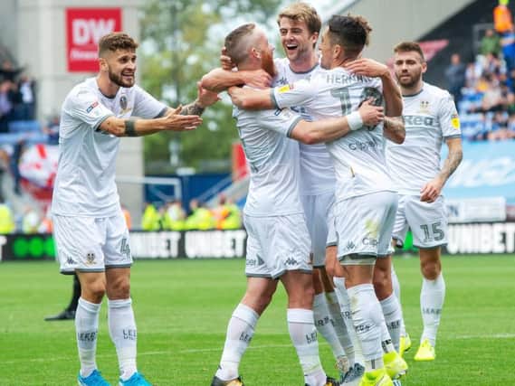 LOVING LIFE: Leeds United's no 9 Patrick Bamford is mobbed by Adam Forshaw and Pablo Hernandez as Mateusz Klich and Stuart Dallas look on following his opening strike in last month's 2-0 win at Wigan Athletic. Picture by Bruce Rollinson.