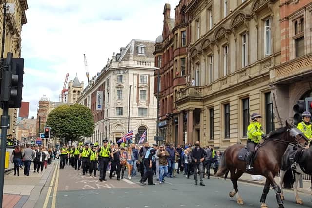 Police horses leading a march of pro-Tommy Robinson supporters through Leeds