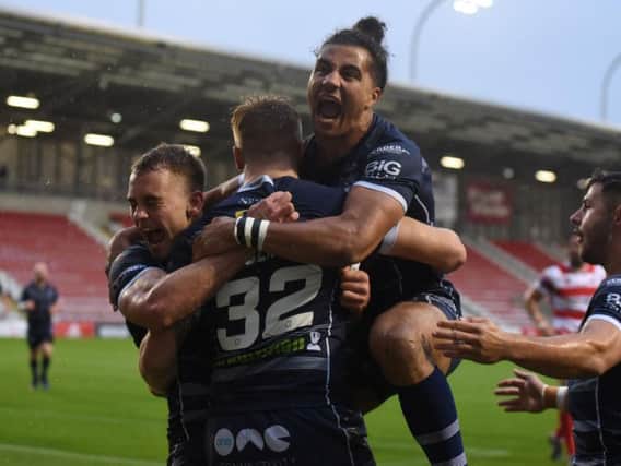 Featherstone Rovers' Ash Golding leaps on try-scorer Alex Sutcliffe after he scores one of his tries against Leigh Centurions.(PIC: DEC HAYES)