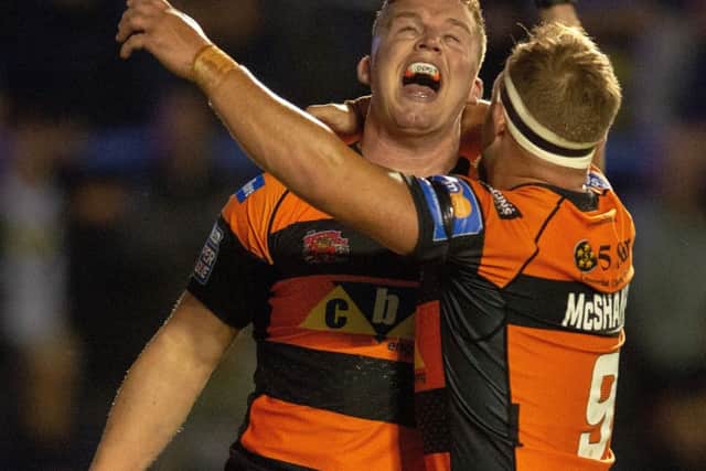 Adam Milner celebrates his try with Paul McShane