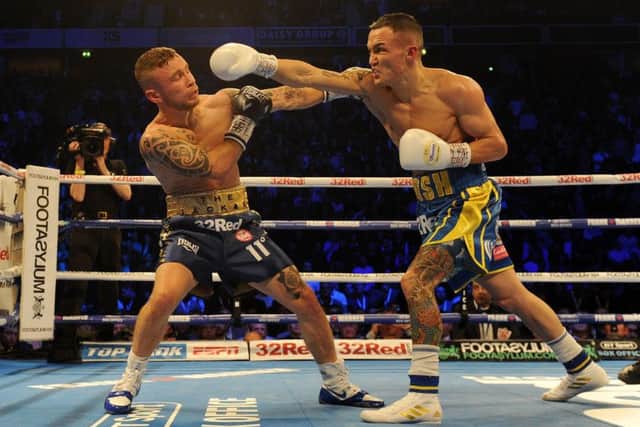 Josh Warrington and Carl Frampton clash during their IBF Featherweight World title fight at Manchester Arena in December last year.