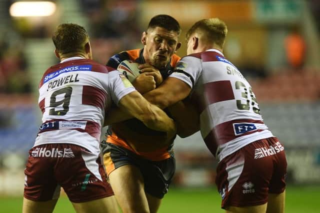 Castleford's Chris Clarkson is tackled by Wigan's Sam Powell and Morgan Smithies.
 Picture:  Jonathan Gawthorpe