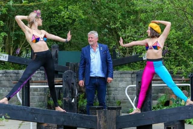 Two models seen with garden designer Mark Gregory within his "Welcome to Yorkshire Garden" during the 2019 Chelsea Flower Show. (Photo by Dinendra Haria/SOPA Images/LightRocket via Getty Images)