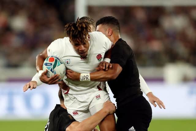 England's Anthony Watson is tackled by New Zealand's George Bridge (left).