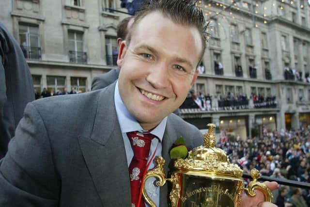 On top of the world: England's Mark Regan holds the Webb Ellis Cup during the victory parade in 2003.