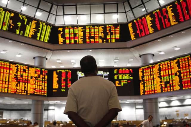 Watching the market: Warning signs from China, Europe and the US lead some to believe a downturn is overdue. PHOTO: AP Photo/Vincent Thian