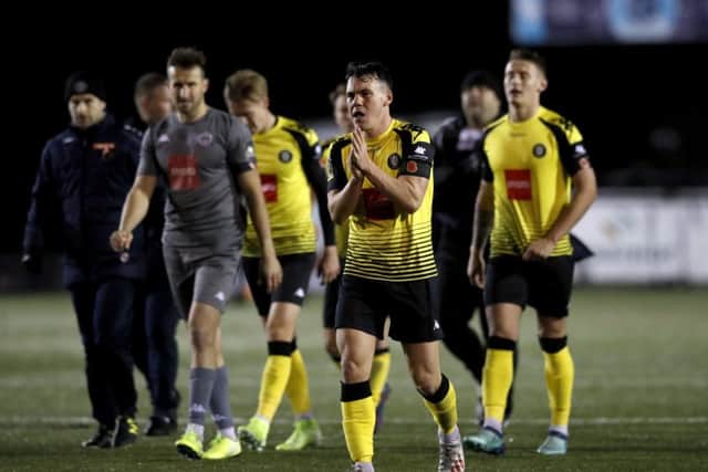 Harrogate Town playersshow their disappointment as they leave the pitch after the final whistle, losing 2-1 to League One Portsmouth in the first round of the FA Cup. Picture: Martin Rickett/PA