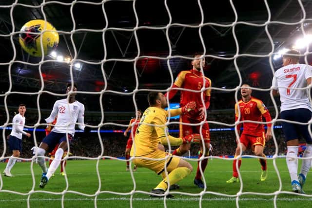 Montenegro's Aleksandar Sofranac (second right) scores an own goal to put England 6-0 up.