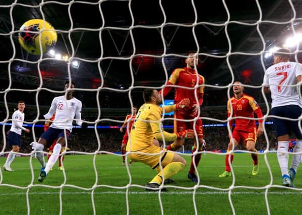 Montenegro's Aleksandar Sofranac (second right) scores an own goal to put England 6-0 up.