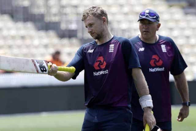 Ready to hit back: England's Joe Root gestures with his bat as coach Chris Silverwood watches.