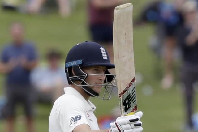 England's Joe Root gestures with his bat as he reaches 150 runs on day four of the second cricket test between England and New Zealand at Seddon Park in Hamilton, New Zealand (AP Photo/Mark Baker)