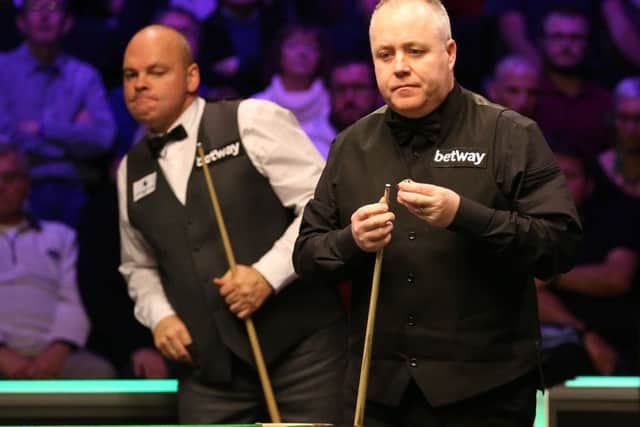 John Higgins (right) and Stuart Bingham during day eight of the Betway UK Championship at the York Barbican.