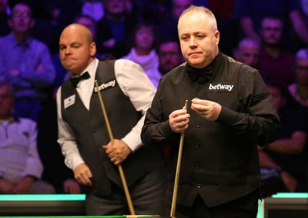John Higgins (right) and Stuart Bingham during day eight of the Betway UK Championship at the York Barbican.