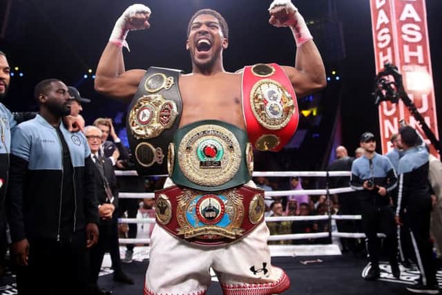 Anthony Joshua with the IBF, WBA, WBO and IBO World Heavyweight belts (Picture: Nick Potts/PA Wire ).