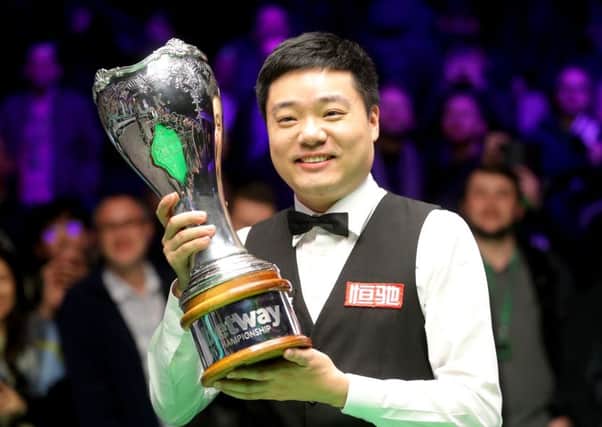 Ding Junhui celebrates with the trophy.