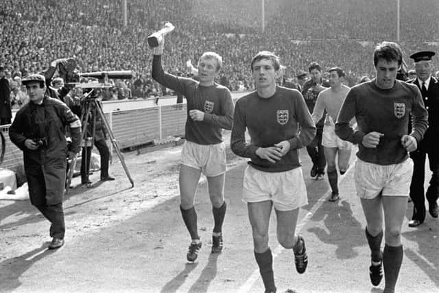 Martin Peters, second right, next to Geoff Hurst, far right, as England captain Bobby Moore leadsd the World Cup winners around Wembley after beating Germany 4-2 in 1966. Picture: PA.