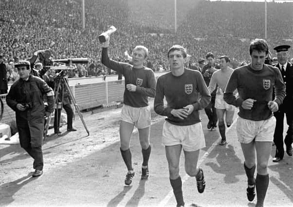 Martin Peters, second right, next to Geoff Hurst, far right, as England captain Bobby Moore leadsd the World Cup winners around Wembley after beating Germany 4-2 in 1966. Picture: PA.