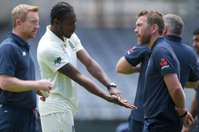 BAD SIGN: England bowler Jofra Archer chats with physio Craig de Weymarn at Newlands in Cape Town. Picture: Stu Forster/Getty Images