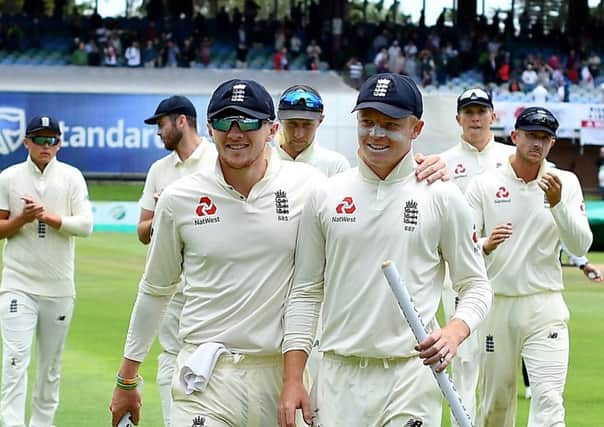 Dominic Bess and Ollie Pope lead England's players from the field after their third Test victory against South Africa in Port Elizabeth. Picture: Ashley Vlotman//Getty Images