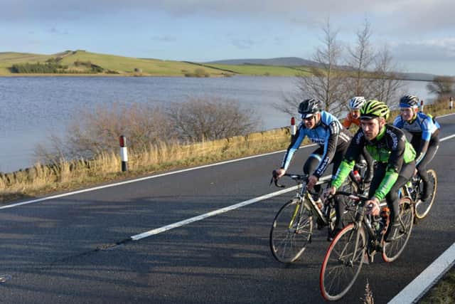 Cyclists pass Chelker reservoir between Addingham and Skipton which is used as part of this year's stage from Leeds to Harrogate.  Picture by Bruce Rollinson