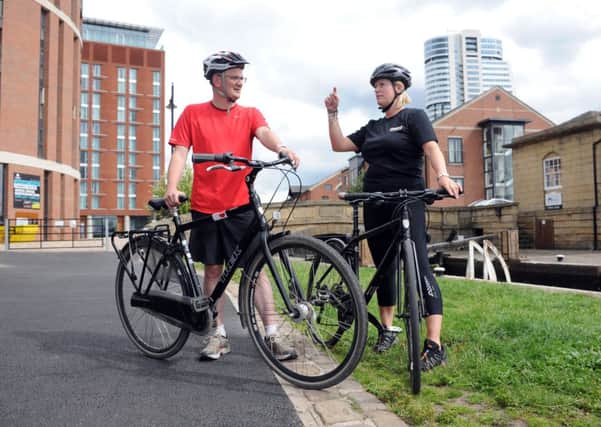 Metro chairman Coun James Lewis takes a cycling refresher course from Ginny Leonard, Cycling Development Officer at CTC - The national cycling charity, to help celebrate the green light for the £30m Leeds-Bradford cycleway.