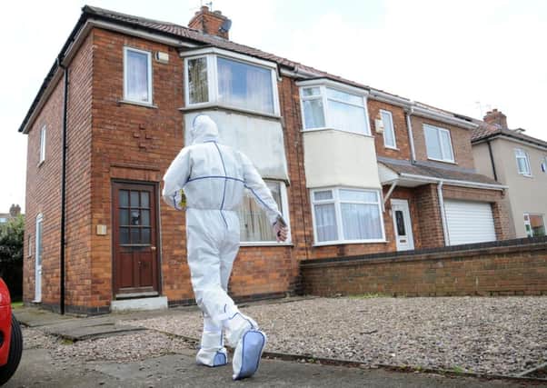 A forensic officer outside a house in York where police are searching after a man was arrested in connection with the disappearance of Claudia Lawrence.