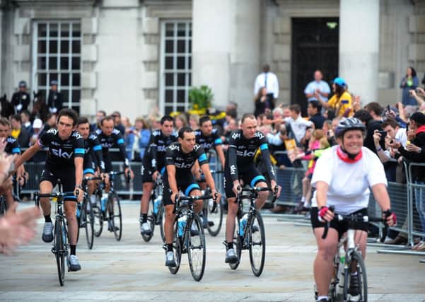 Chris Froome (right) leads Team Sky through Millennium Square ahead of the Team Presentation at Leeds' First Direct Arena on Thursday. Picture by Jonathan Gawthorpe.